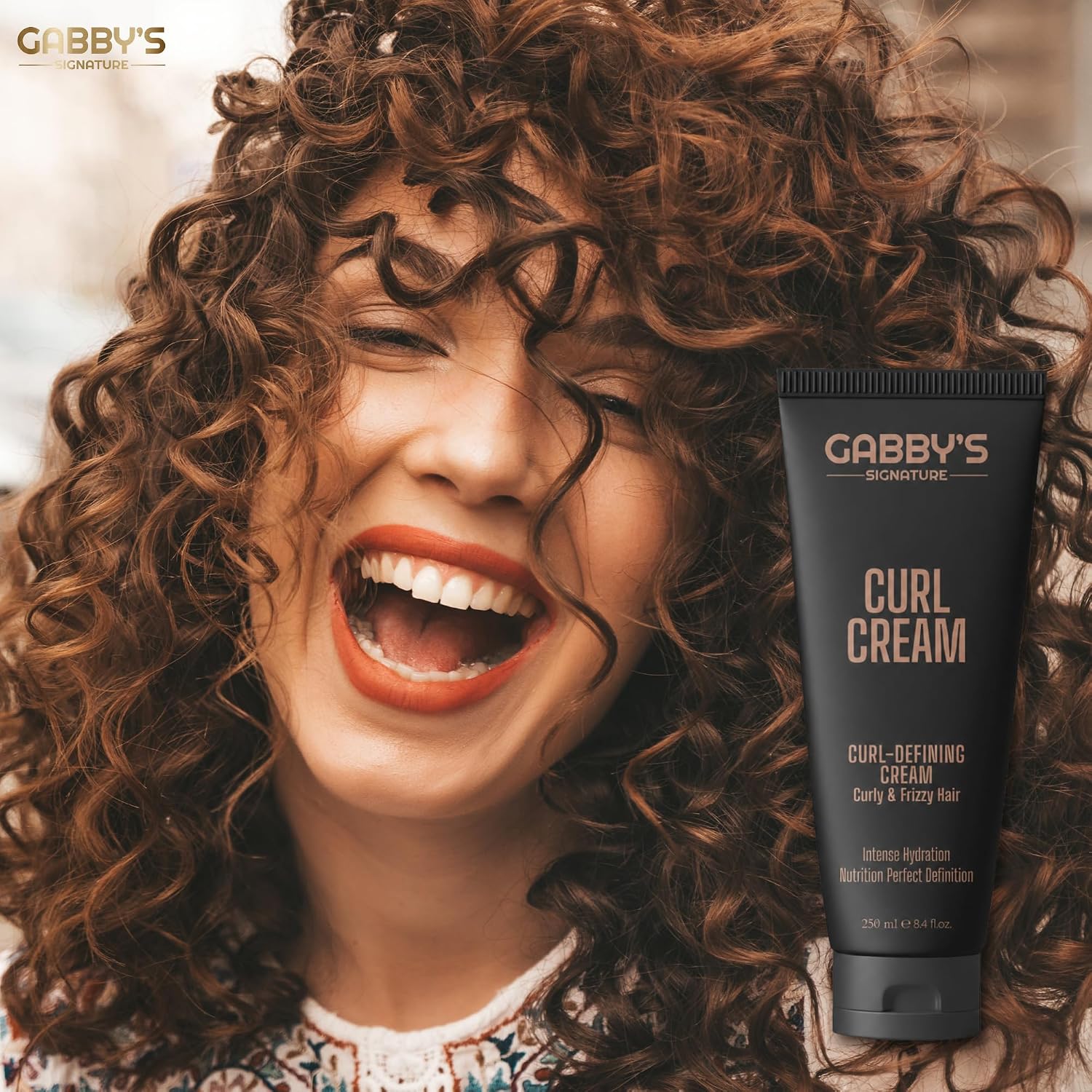 Woman with curly hair next to a tube of Gabby's Curl Cream