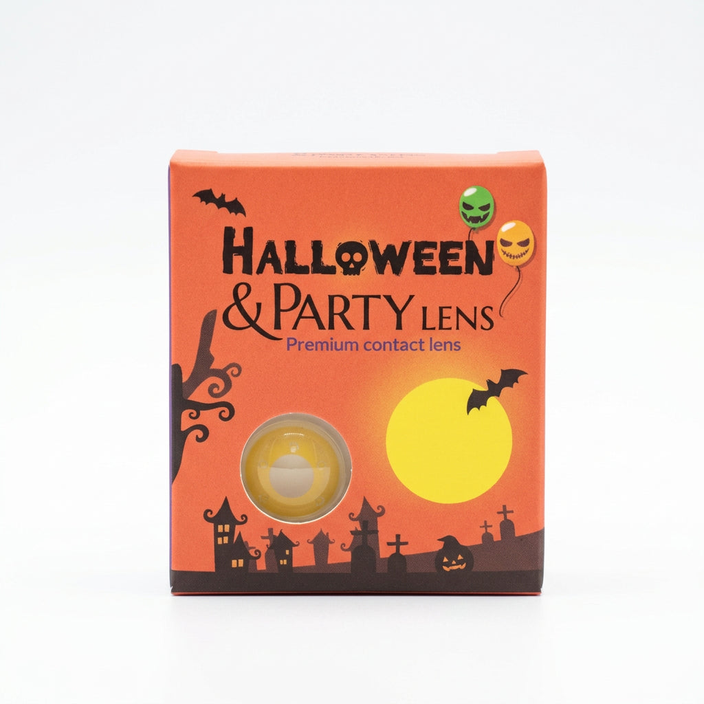 A box of Halloween & Party Contact Lenses placed on a gray counter in a store. The box is orange with black silhouettes of a haunted house, bats, and a graveyard, a large yellow moon graphic, and two circular cutouts showing the yellow and green contact lenses inside.