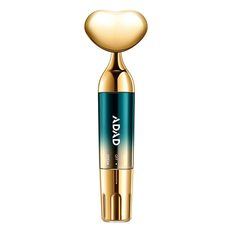 Gold heart-headed massager with teal body marked ADAD on a plain white background