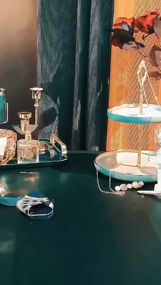 Still frame from the product video showing a dressing table with perfume bottles and jewellery trays