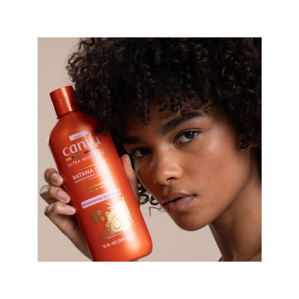 Model holding Cantu Ultra Moisture Nourishing Shampoo