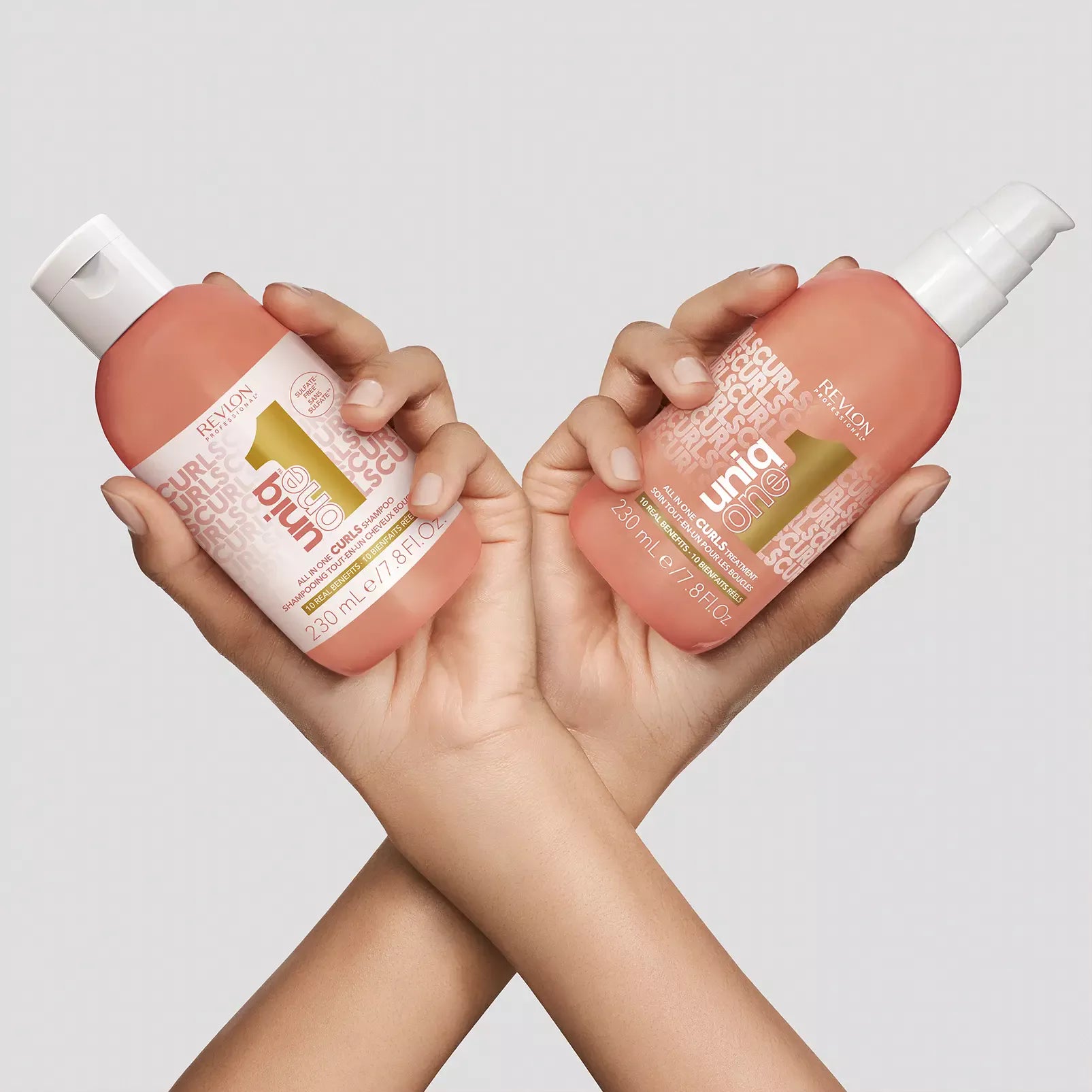 UniqOne Curls Shampoo and treatment held in hands