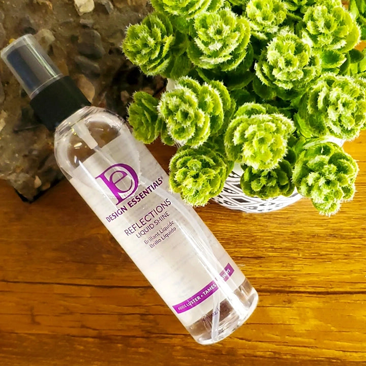 Design-Essentials-Reflections-Liquid-Shine-4oz-laying-down-with-flowers. 