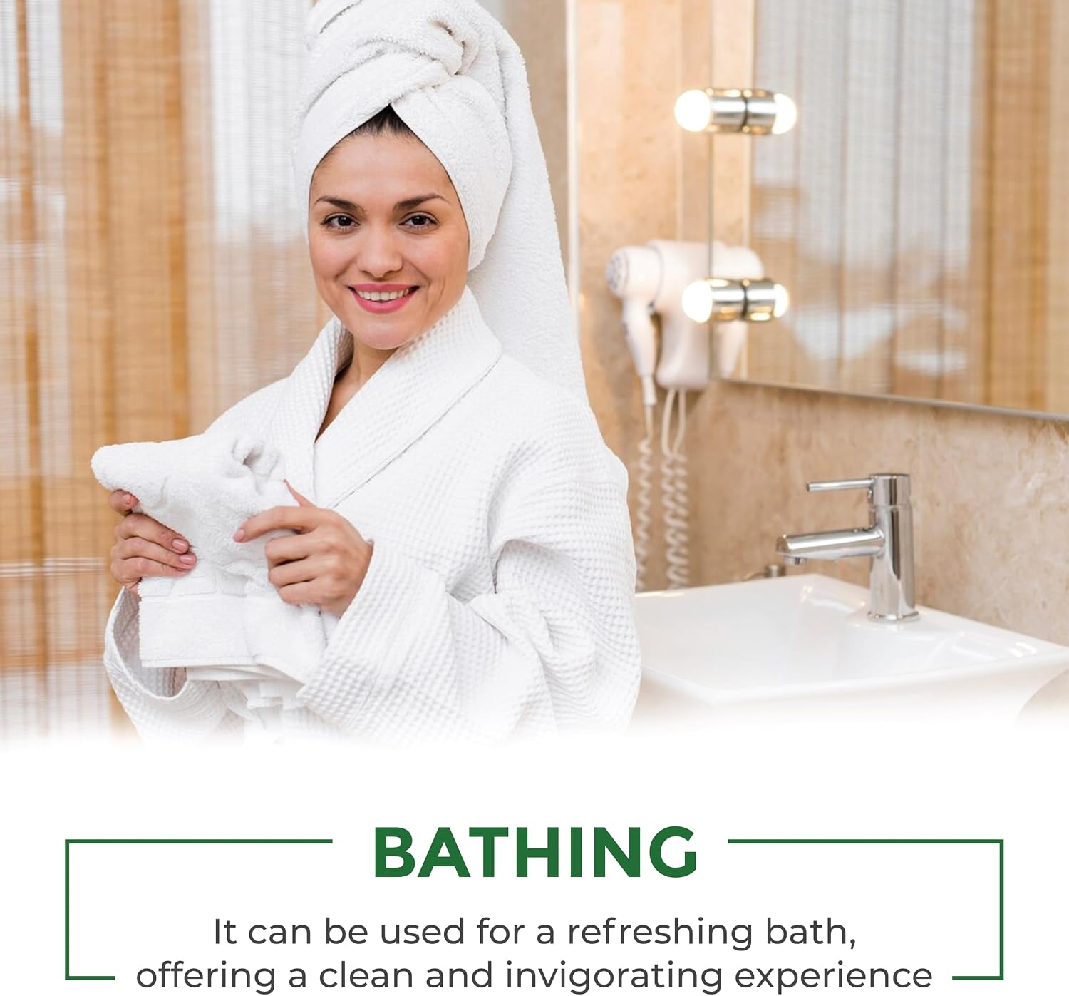 A smiling woman in a white bathrobe with a white towel wrapped around her head stands in a bathroom holding a folded white towel. A sink, mirror with lights, and a hair dryer are visible in the background, with text at the bottom reading 'BATHING' and a descriptive caption.
