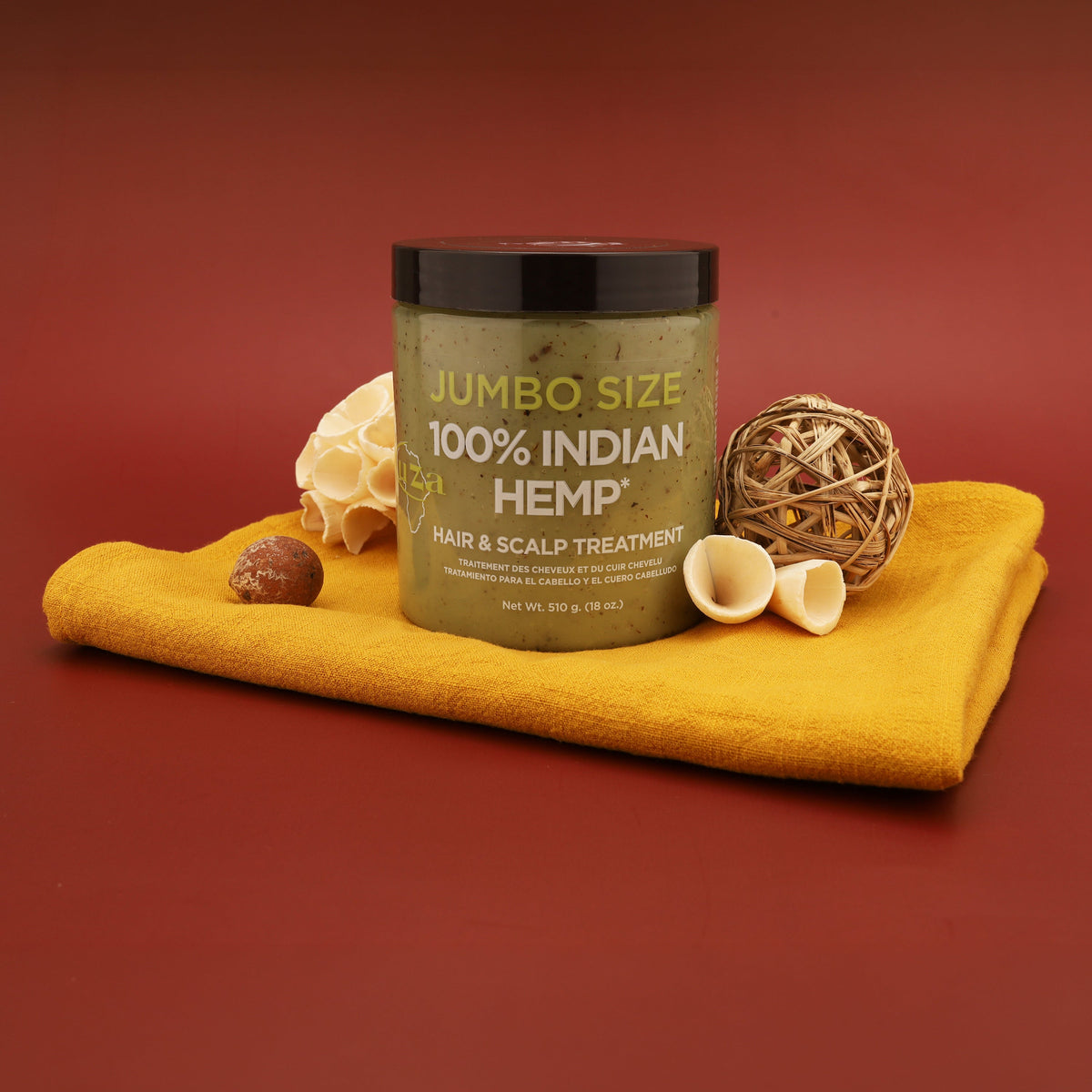Jumbo Size jar on a folded yellow cloth with a sponge, wooden ball and shells on a red background