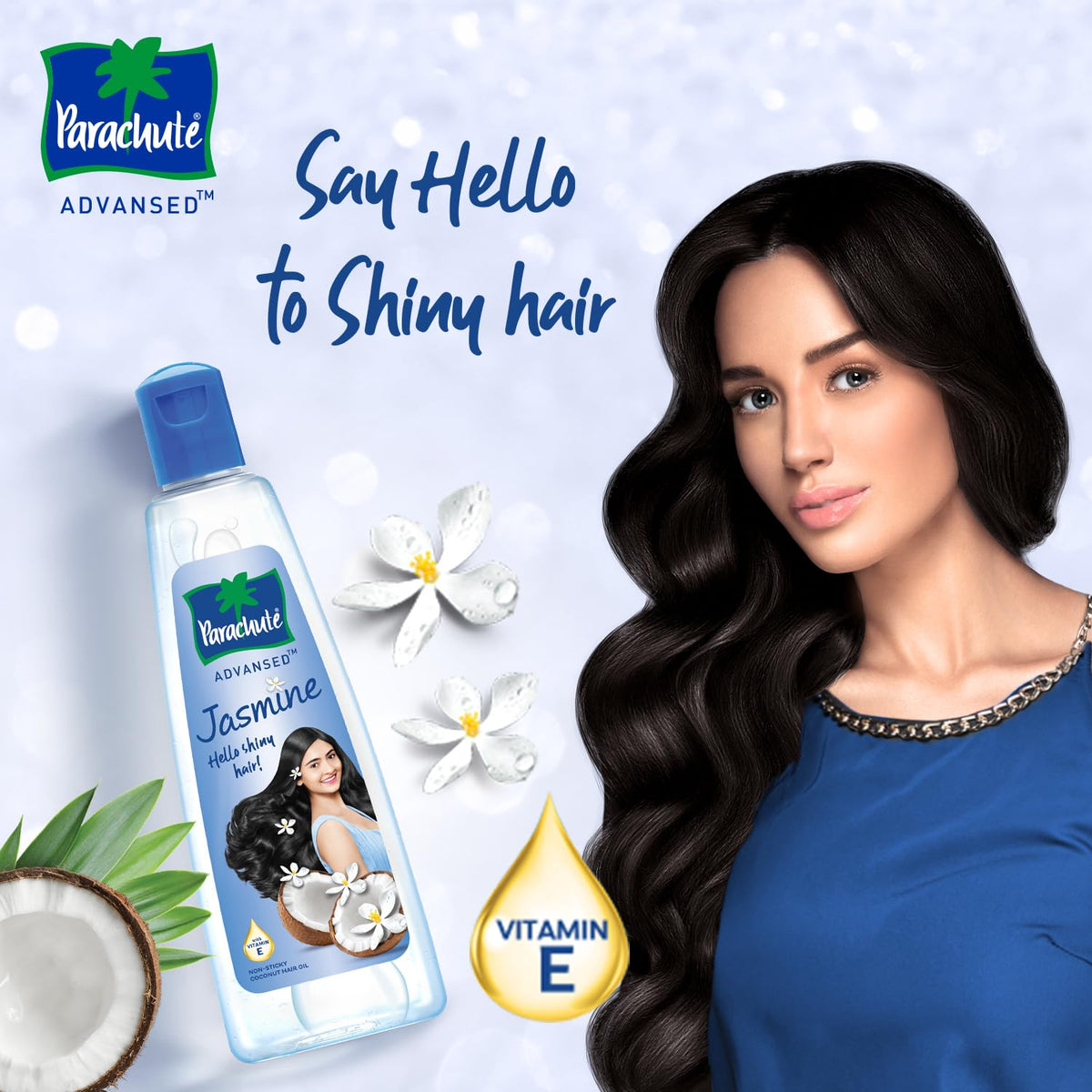 Woman with long dark wavy hair beside a bottle of Parachute Advansed Jasmine hair oil with a vitamin E drop and the caption Say Hello to Shiny hair